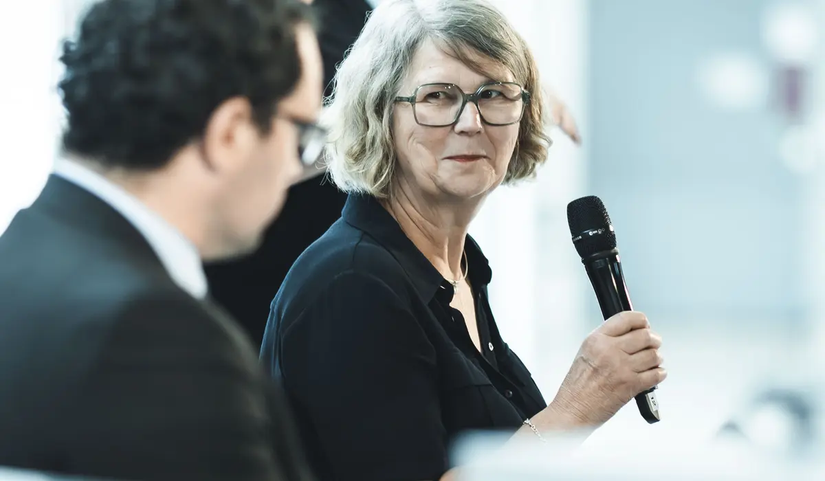 Susanne Menge im Gespräch auf einer Bühne auf der Fraktionsebene des Reichstags