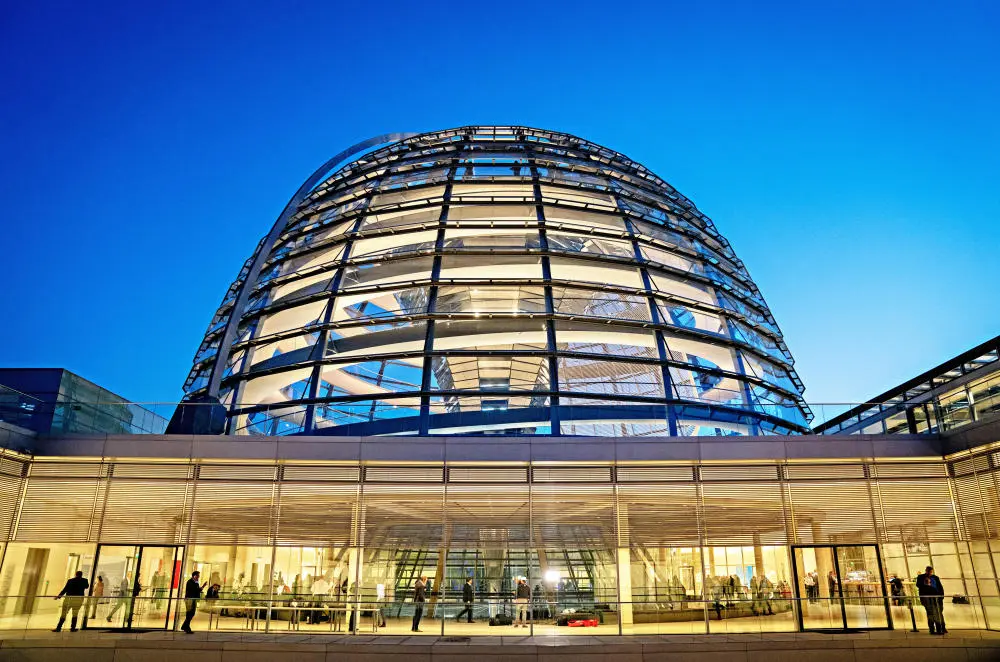 Blick auf die beleuchtete Reichstagskuppel und die Fraktionsebene.