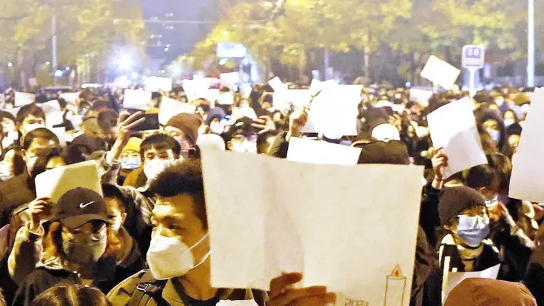 Demonstranten in China halten weiße Blätter nach oben