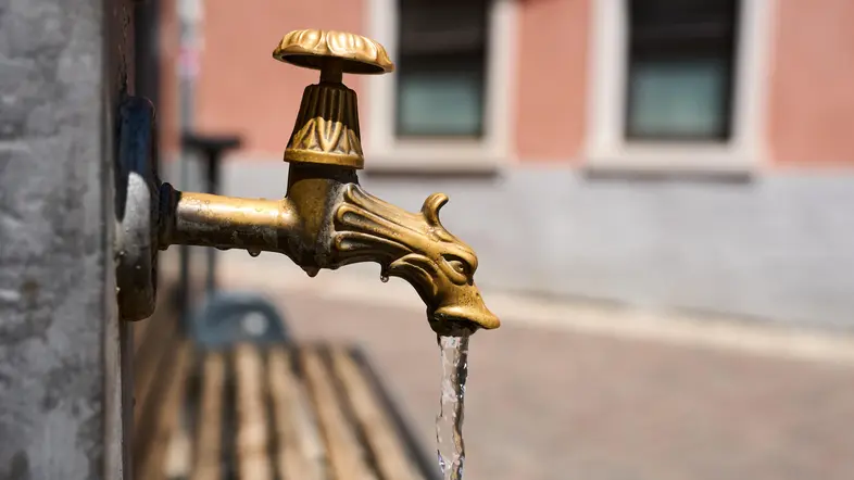 Erfrischendes Nass im heißen Sommer: Wasser läuft aus einem Stadtbrunnen