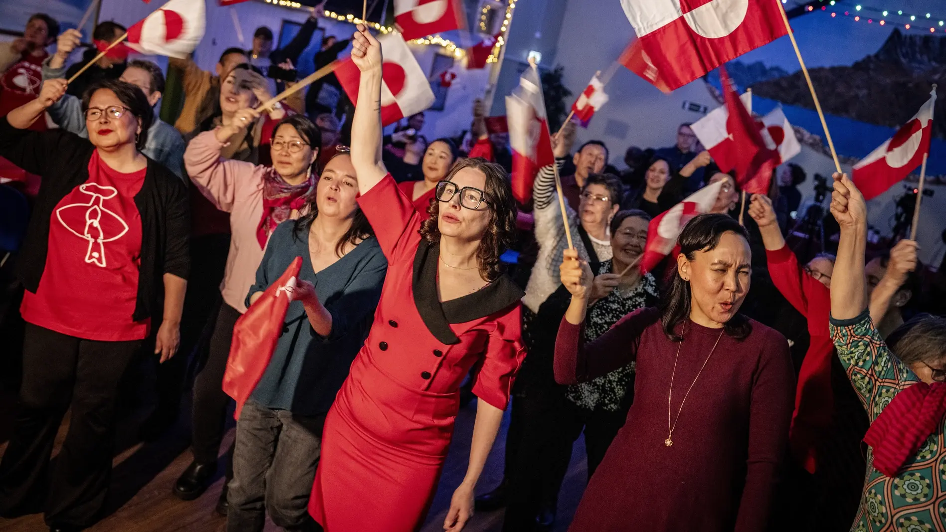 Anhänger der Inuit-Partei schwenken Grönlandfahnen